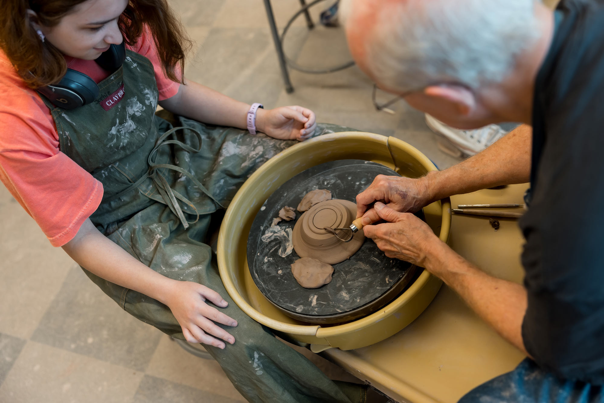 Man teaching student at the pottery wheel